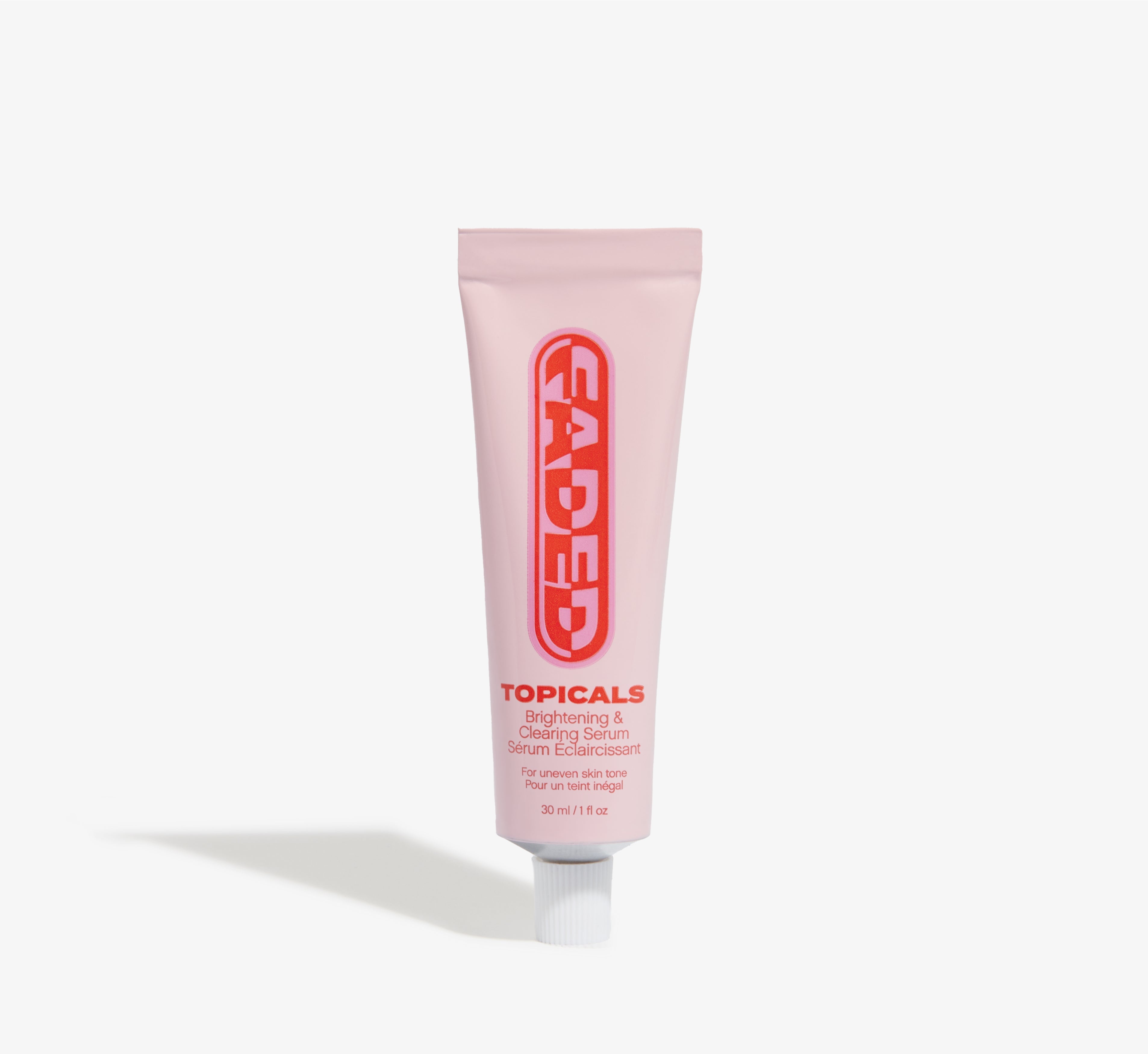 Brightening serum from Topicals Faded shown as a pink 30ml tube with bold red Faded branding standing upright on a white background.