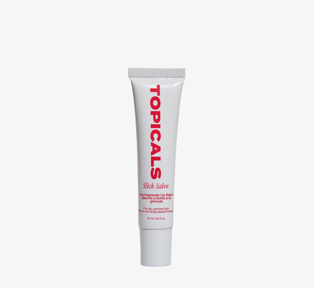 Moisturizing lip balm from Topicals Slick Salve in Pomegranate shown as a single white tube standing upright on a white background.