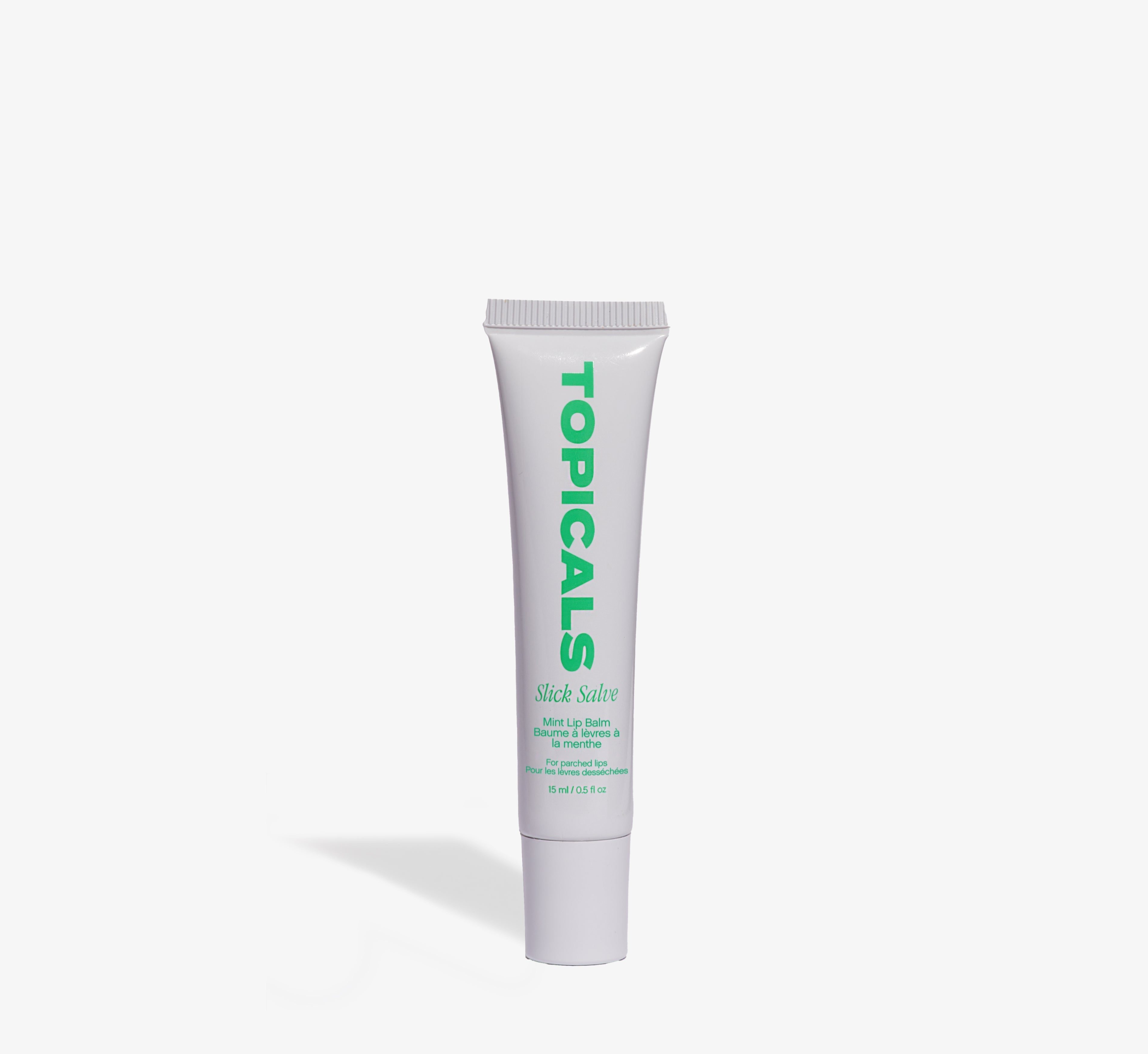 Mint lip balm from Topicals Slick Salve shown as a single white 15ml squeeze tube with green branding on a white background.