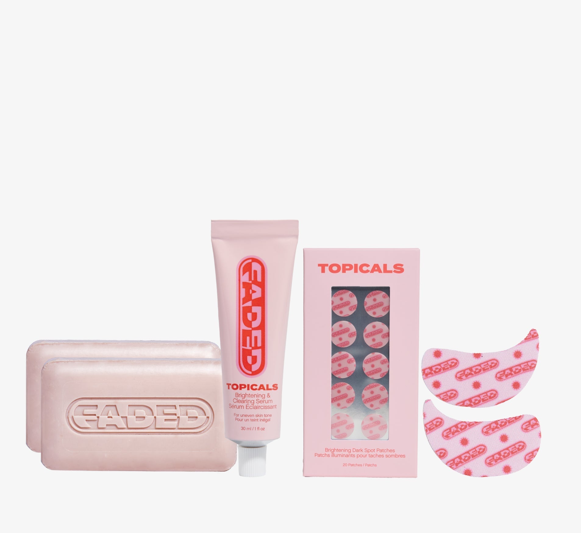 Brightening skincare collection from Topicals Faded featuring two cleansing bars, a serum tube, dark spot patches, and under-eye masks on a white background.